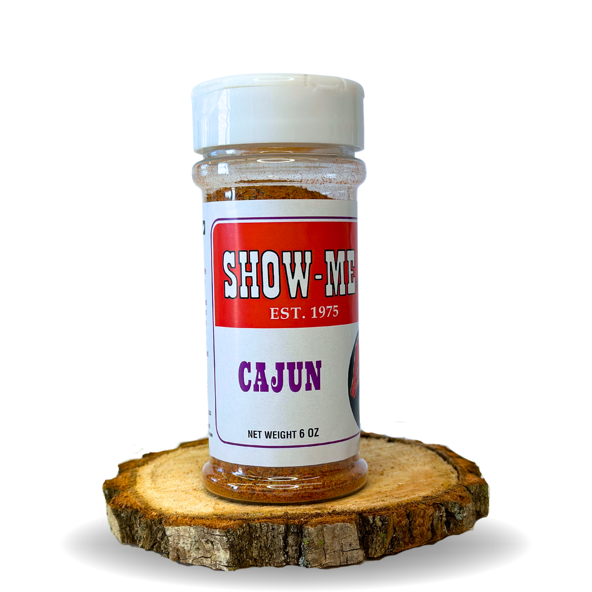 Show-Me® Cajun Seasoning 6 oz shaker on a wood round