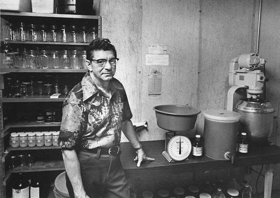 Black-and-white photo of founder Harry Berrier in the basement where Show-Me® Bar-B-Q Sauce began