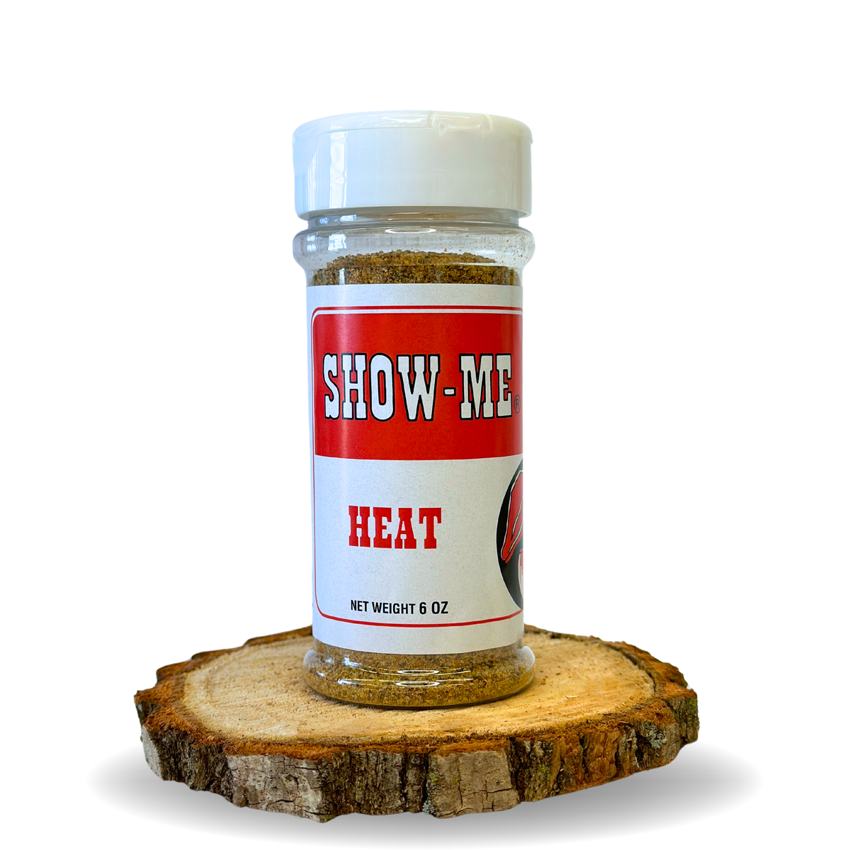 Show-Me® Heat Rub 6 oz shaker on a wood round