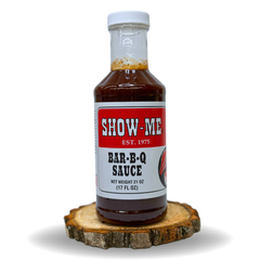 Show-Me® Classic Bar-B-Q Sauce pint bottle on a wood round