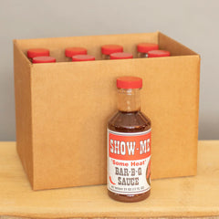 Case of 12 Show-Me® 'Some Heat' Bar-B-Q Sauce pint bottles in a cardboard shipping box