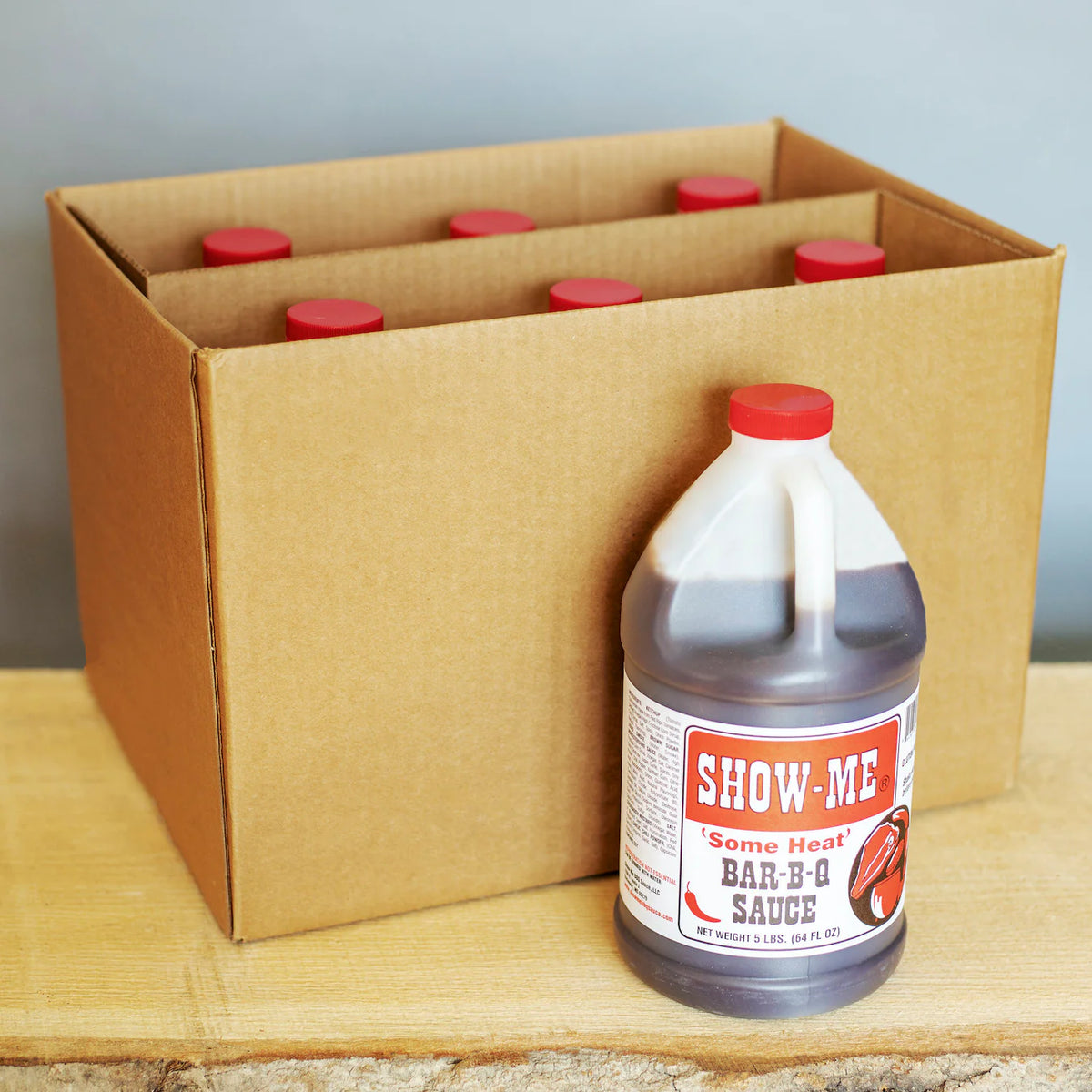 Case of 6 Show-Me® 'Some Heat' Bar-B-Q Sauce half-gallon jugs in a cardboard box